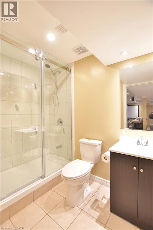 Full bathroom featuring vanity, a shower stall, light tile patterned flooring, and recessed lighting - 512 Terrington Crescent, Kitchener, ON