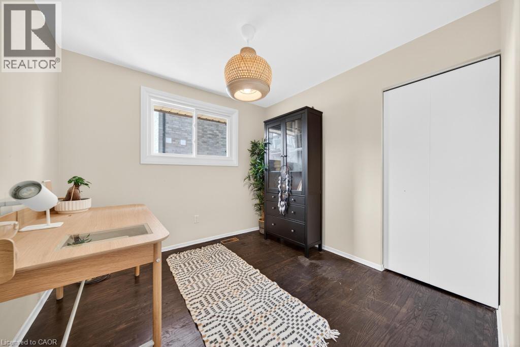 Hardwood-finish flooring complements neutral wall tones and a white ceiling - 19 Glen Forest Drive, Hamilton, ON
