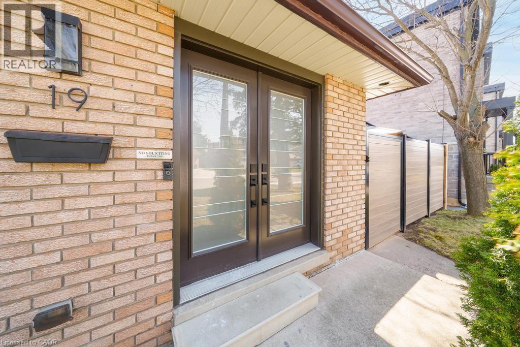 Brick exterior featuring a double-door entry with frosted glass inserts - 19 Glen Forest Drive, Hamilton, ON