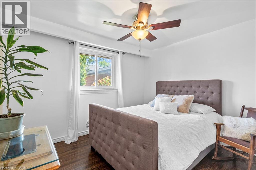 Bright room featuring wood-finish flooring, a window with white trim, and a ceiling fan with light fixture - 1083 Melton Drive, Mississauga, ON