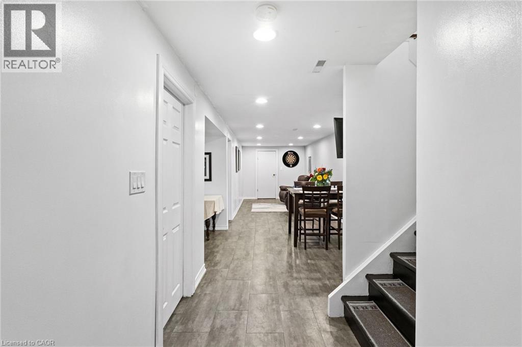 Spacious hallway featuring wood-finish flooring extending through to an open-concept living area - 1083 Melton Drive, Mississauga, ON
