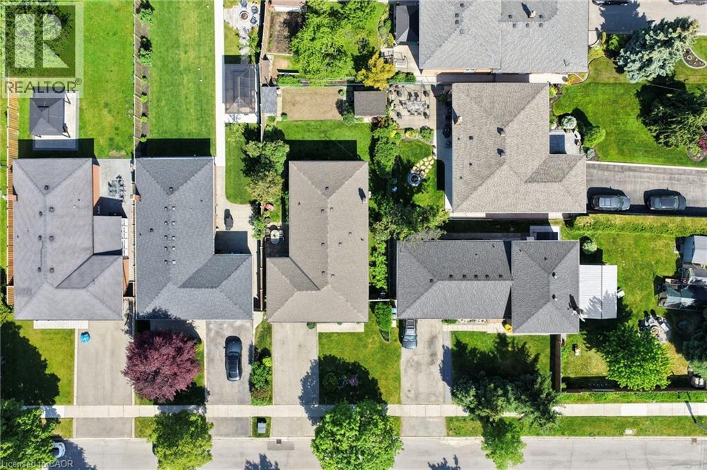 Overhead view of a residential property featuring a dark shingle roof, a paved driveway, and a front yard with mature trees - 1083 Melton Drive, Mississauga, ON
