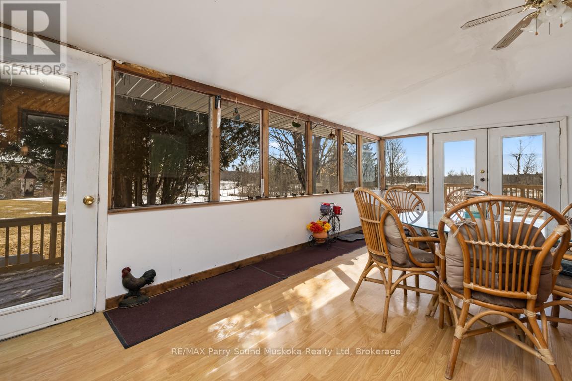 Sunroom wrapped in windows - 39 Hardies Road, Mckellar, ON