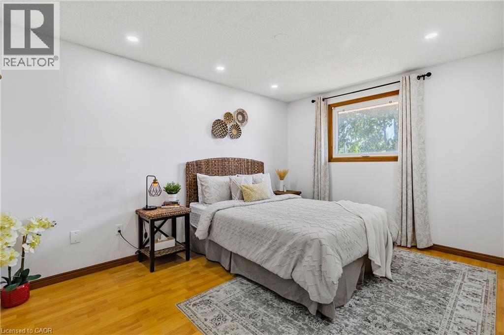 Bright room featuring a single window with wood-finish trim, recessed lighting, and wood-finish flooring - 102 Juniper Drive, Hamilton, ON