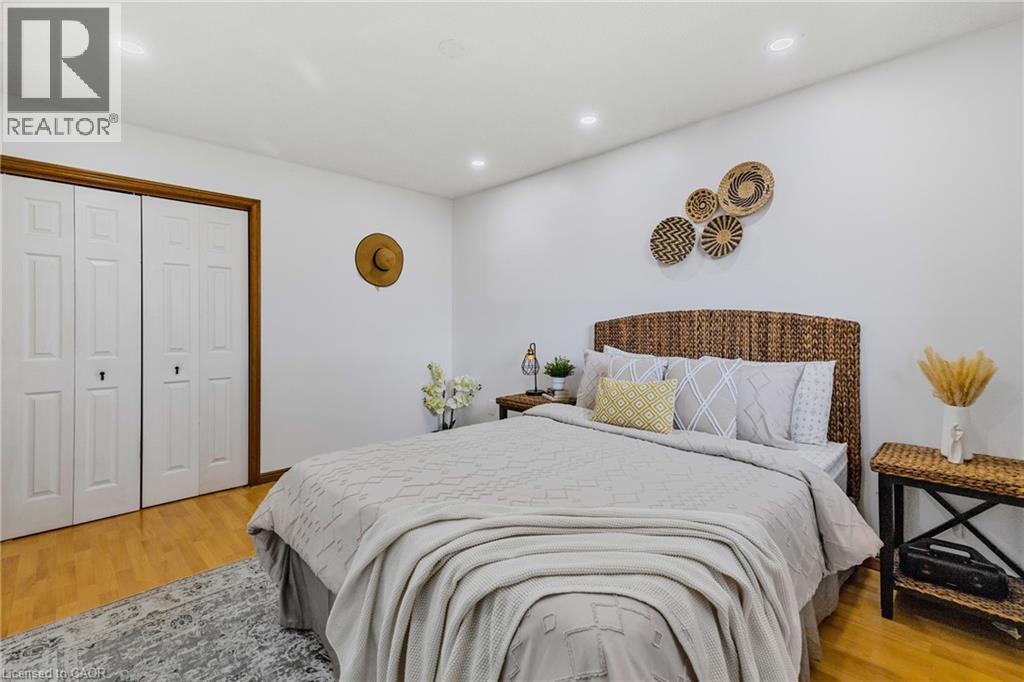 Bedroom featuring wood-finish flooring, recessed lighting, and white walls - 102 Juniper Drive, Hamilton, ON