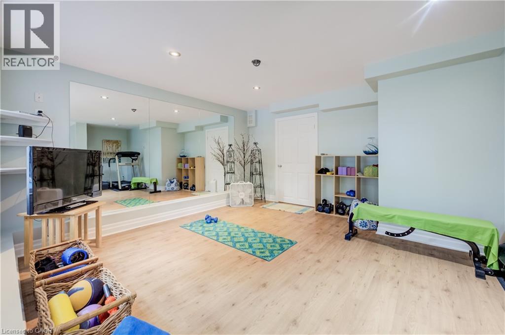 Recreational space featuring light wood-finish flooring, recessed lighting, a full-wall mirror. - 314 Glasgow Street, Kitchener, ON