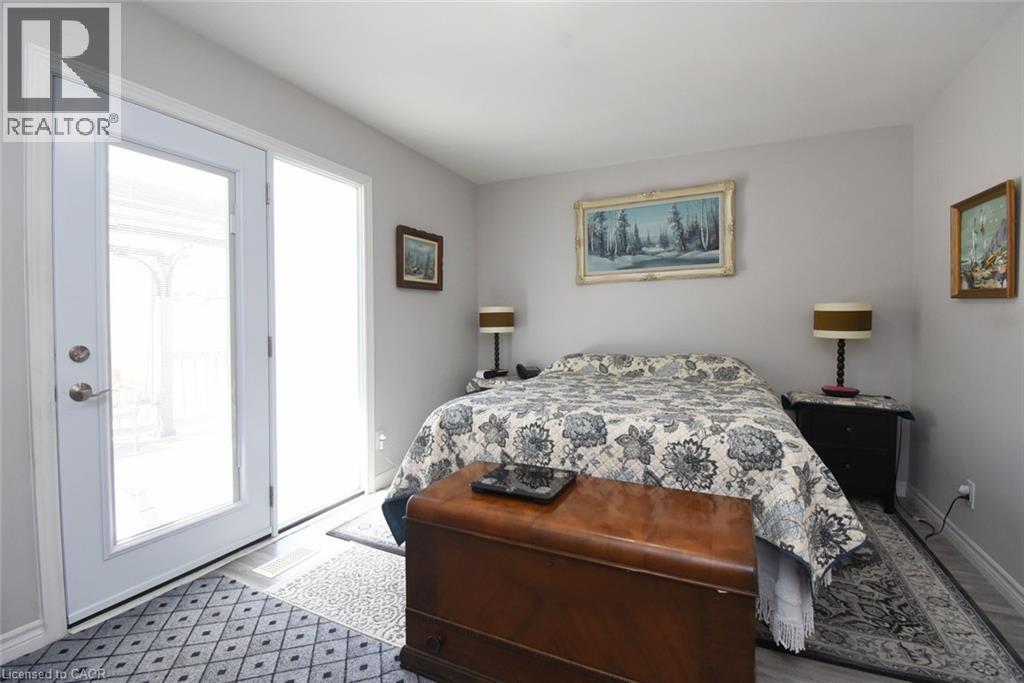 Room featuring a french door, light gray wall paint, and wood-finish flooring - 185 Rosslyn Avenue N, Hamilton, ON - Indoor Photo Showing Bedroom