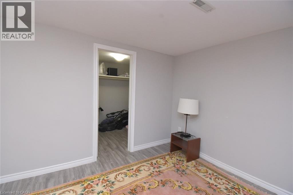Interior room featuring light gray walls, white trim, and wood-finish flooring - 185 Rosslyn Avenue N, Hamilton, ON - Indoor Photo Showing Other Room