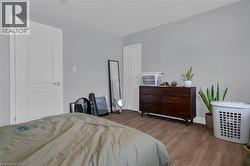 Interior space featuring light gray wall paint and wood-finish flooring -