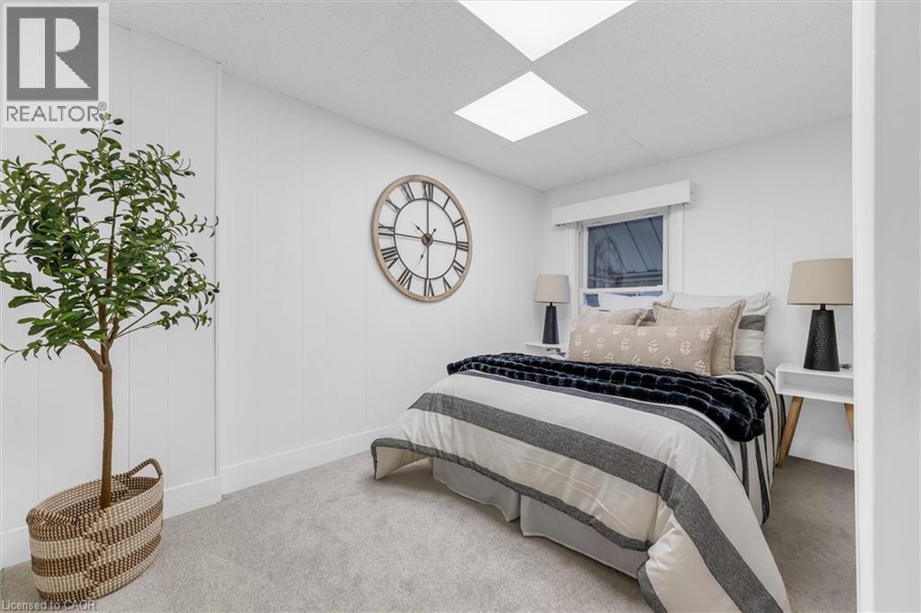 White paneled wall accents complementing neutral carpeting - 11 Ford Street, Hamilton, ON