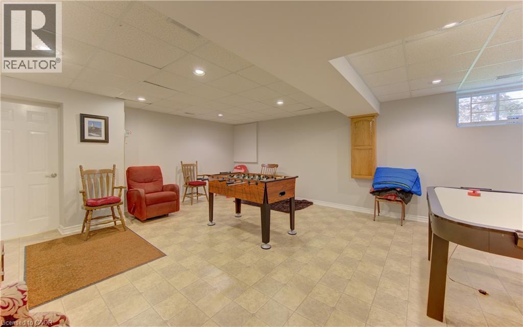 Spacious lower level featuring light-toned tile flooring, recessed lighting, and a window for natural light - 599 Coldstream Drive, Waterloo, ON