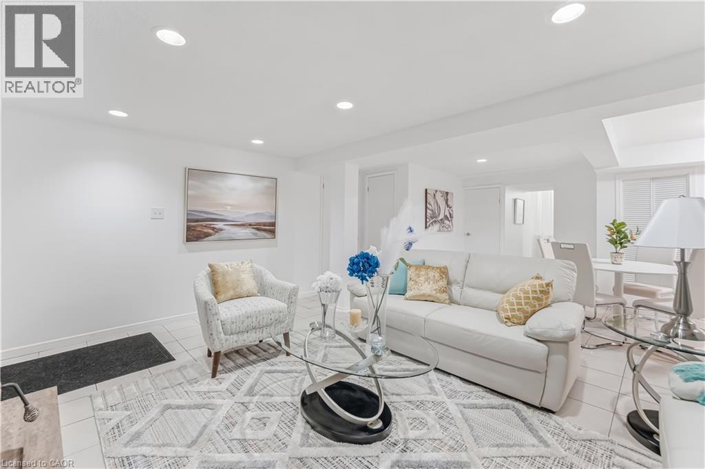 Open-concept living area featuring recessed lighting, light-toned tile flooring, and white painted walls - 3332 Testimony Square, Mississauga, ON