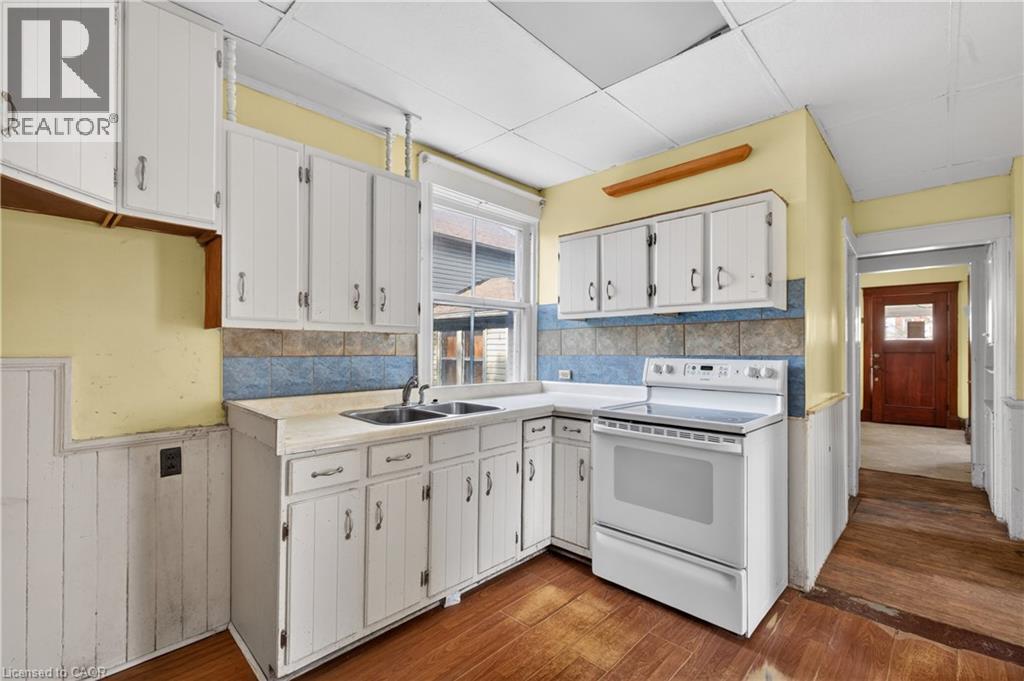 Kitchen featuring wood-finish flooring and white cabinetry - 26 Arthur Avenue, St. Thomas, ON - Indoor Photo Showing Kitchen With Double Sink