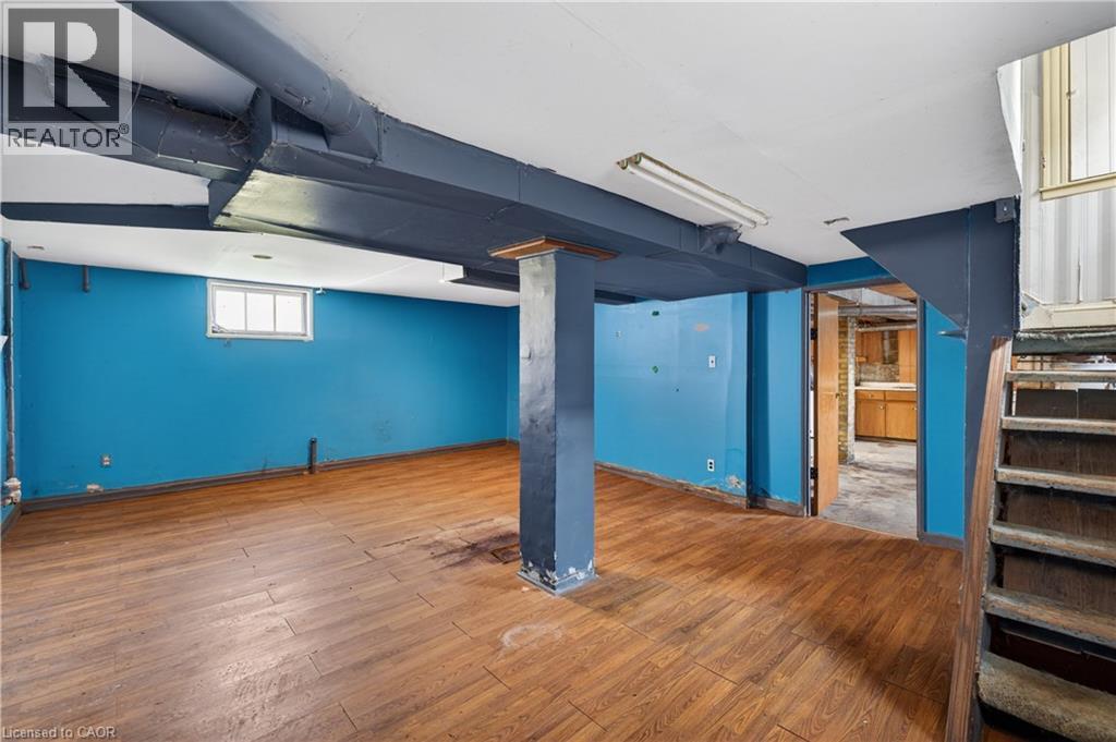 Finished space featuring wood-finish flooring, a painted structural column, and exposed painted ductwork - 26 Arthur Avenue, St. Thomas, ON - Indoor