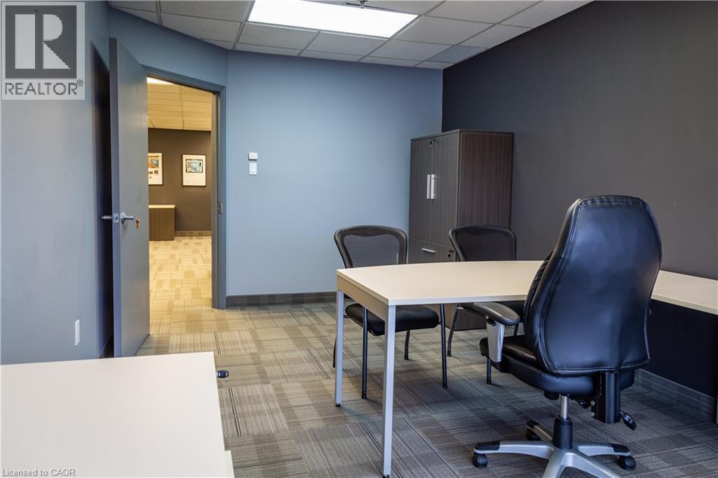 Office space featuring patterned carpet flooring and a drop ceiling with recessed lighting - 5100 South Service Road, Burlington, ON