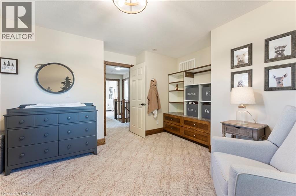 Neutral-toned walls complement the textured carpeting - 182 Governors Road E, Paris, ON