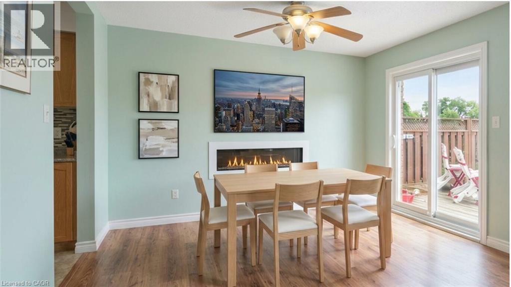Virtually Staged Dining Area - 817 Acadia Drive, Hamilton, ON - Indoor Photo Showing Dining Room With Fireplace