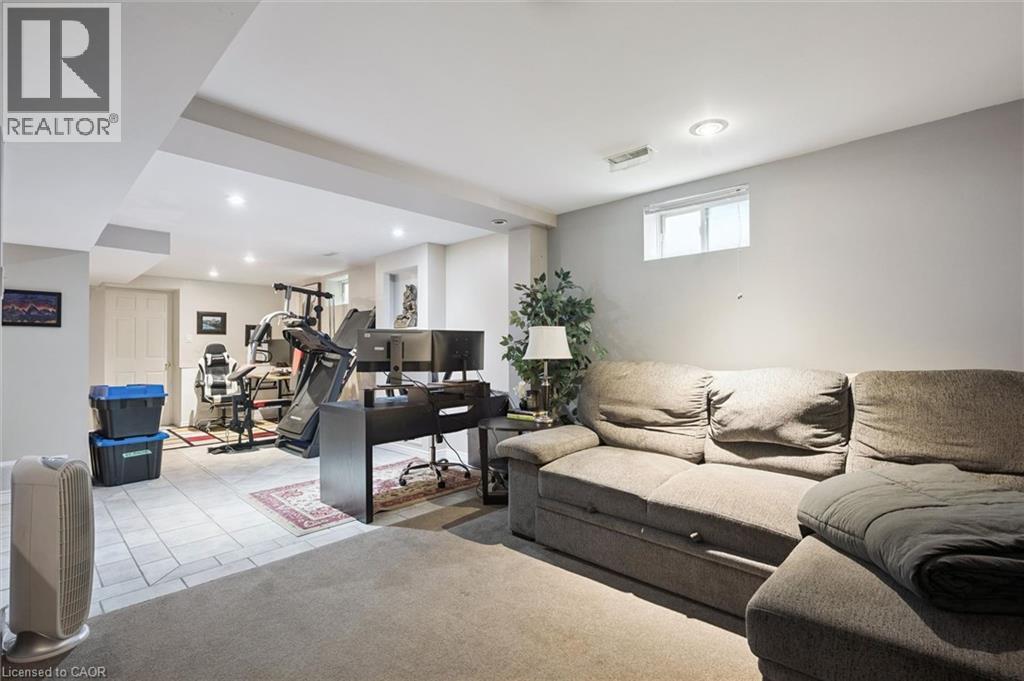 Spacious finished basement featuring recessed lighting and a carpeted lounge area - 817 Acadia Drive, Hamilton, ON - Indoor