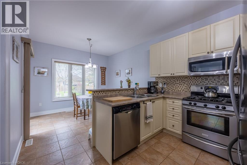Stainless steel appliances including a gas stove and built-in microwave - 21 Kelly Drive, Port Dover, ON