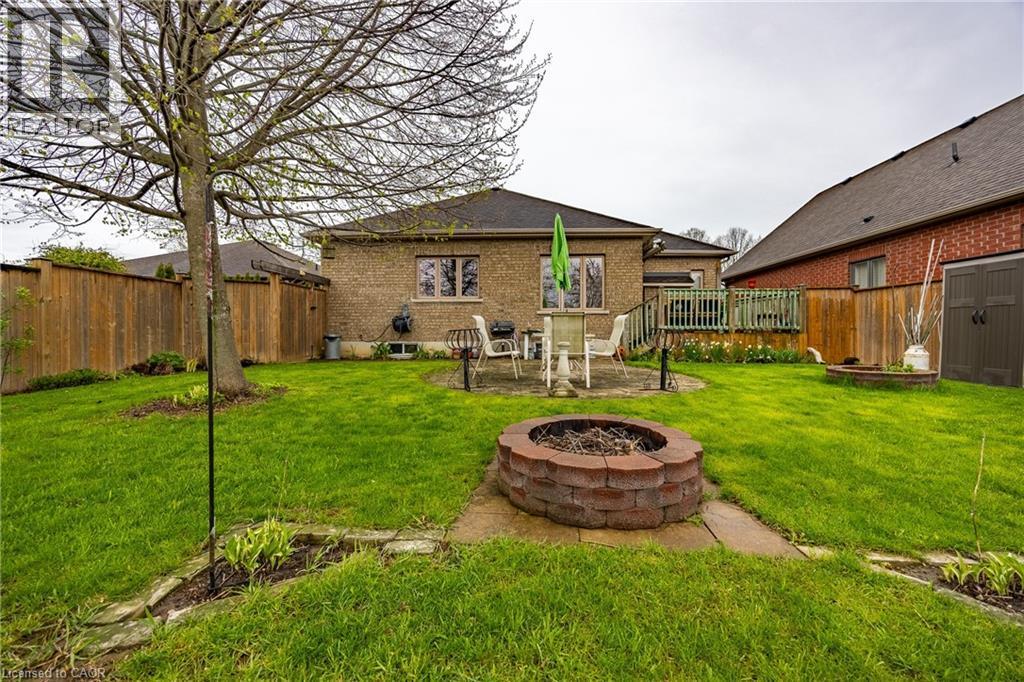 Deck, patio, and firepit zones in the backyard - 21 Kelly Drive, Port Dover, ON