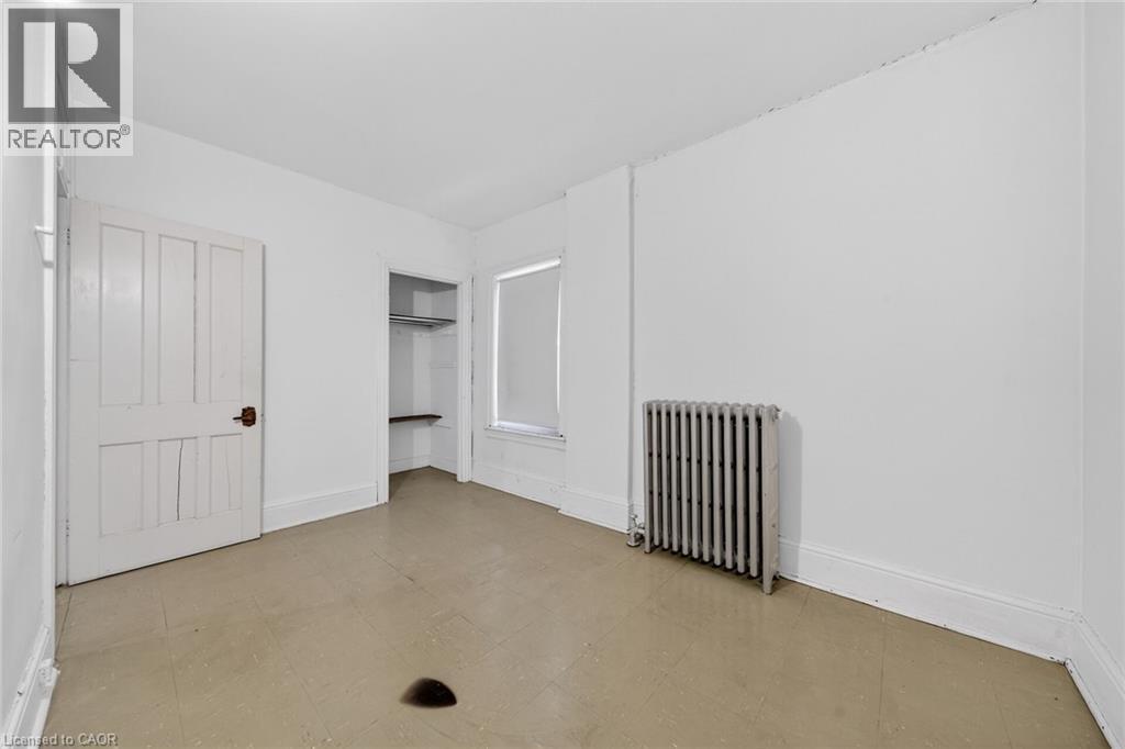 Neutral-toned flooring with white baseboards - 16 Mulberry Street, Hamilton, ON