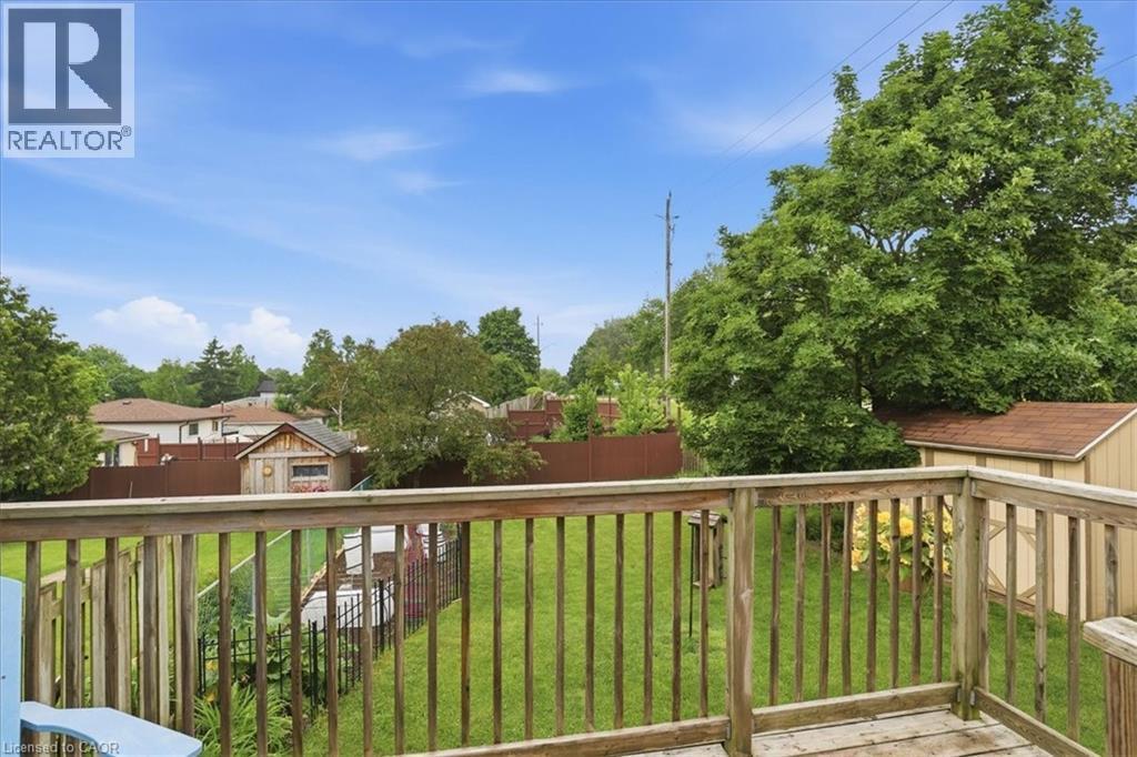 Elevated wood deck overlooking a spacious, fenced backyard - 116 Scott Road, Cambridge, ON