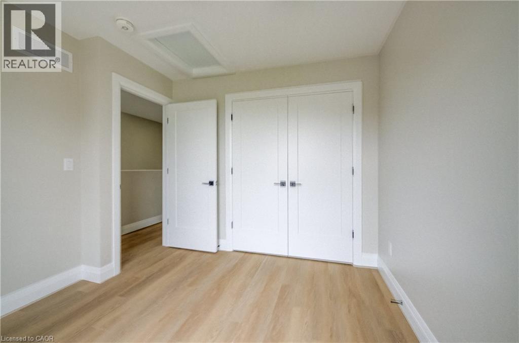 Room featuring light wood-finish flooring, light neutral-toned walls, and white baseboards - 210 Heritage Drive Unit# Upper, Kitchener, ON