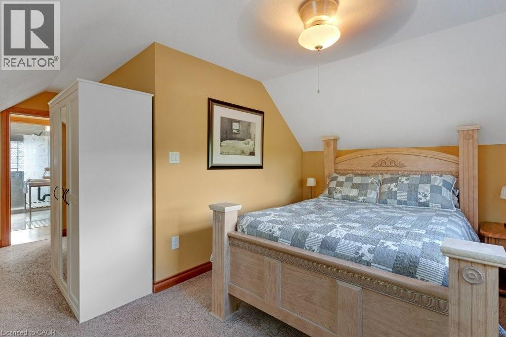 Attic bedroom featuring pitched ceilings and warm wall tones - 3786 Old Beverly Road, North Dumfries, ON