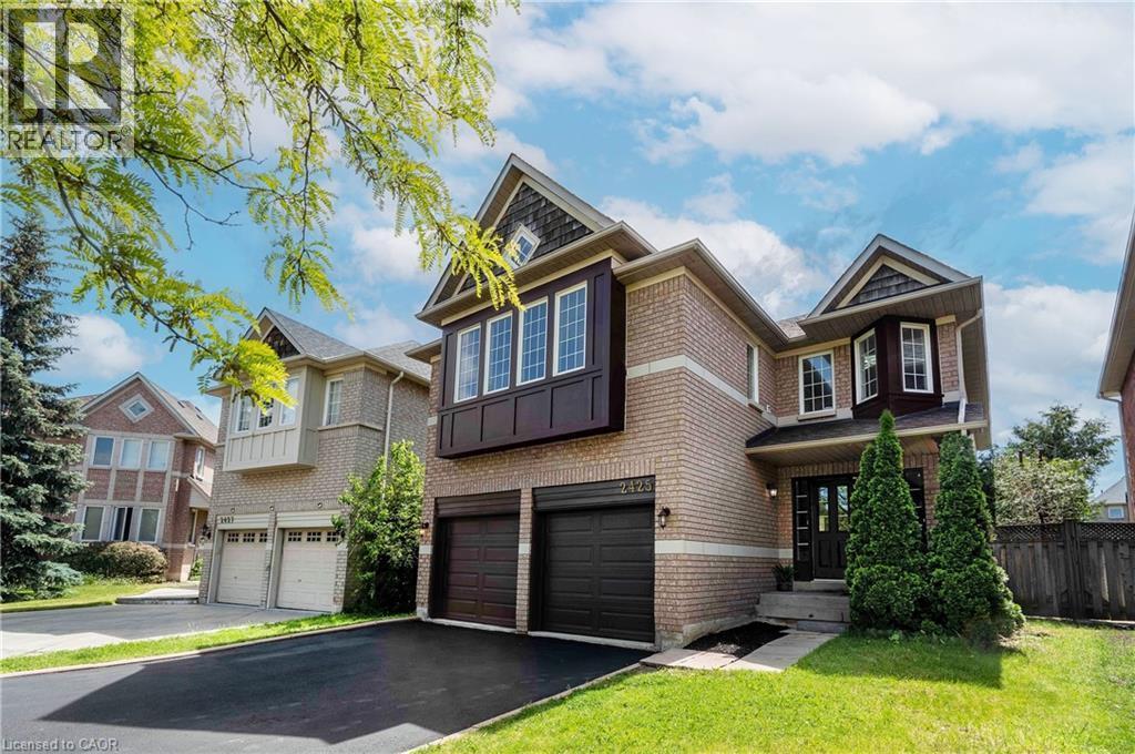 Brick exterior with architectural gables and a double garage - 2425 Nichols Drive, Oakville, ON - Outdoor With Facade