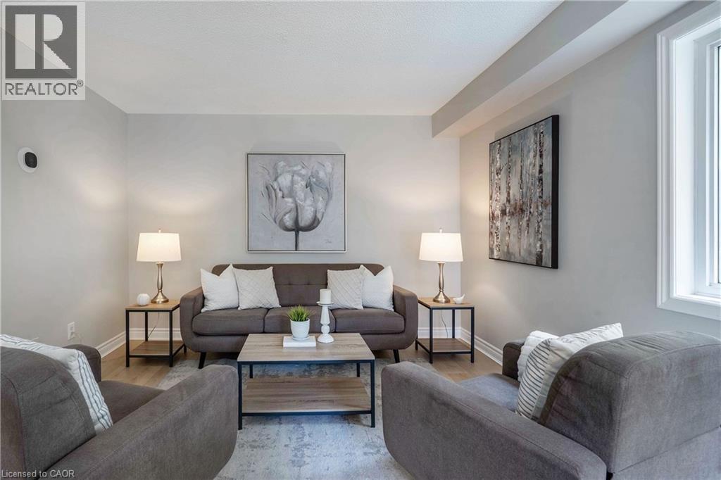 Living area featuring light gray walls and wood-finish flooring - 2425 Nichols Drive, Oakville, ON - Indoor Photo Showing Living Room