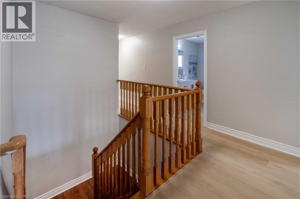 Hardwood staircase with natural wood railings - 2425 Nichols Drive, Oakville, ON - Indoor Photo Showing Other Room