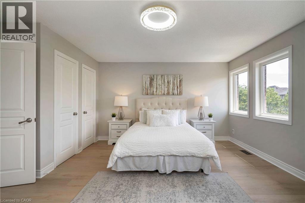 Room featuring wood-finish flooring, light grey painted walls, and white trim - 2425 Nichols Drive, Oakville, ON - Indoor Photo Showing Bedroom