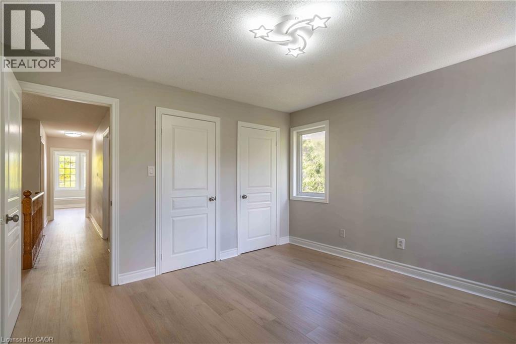 Room featuring light wood-finish flooring, a single window, and two paneled doors - 2425 Nichols Drive, Oakville, ON - Indoor Photo Showing Other Room