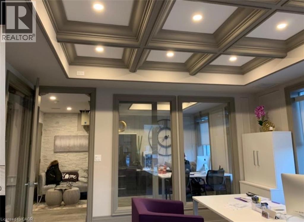 Coffered ceiling with integrated recessed lighting, glass-paneled doors, neutral wall tones, and crown molding - 385 E Wilson Street E Unit# 201, Ancaster, ON
