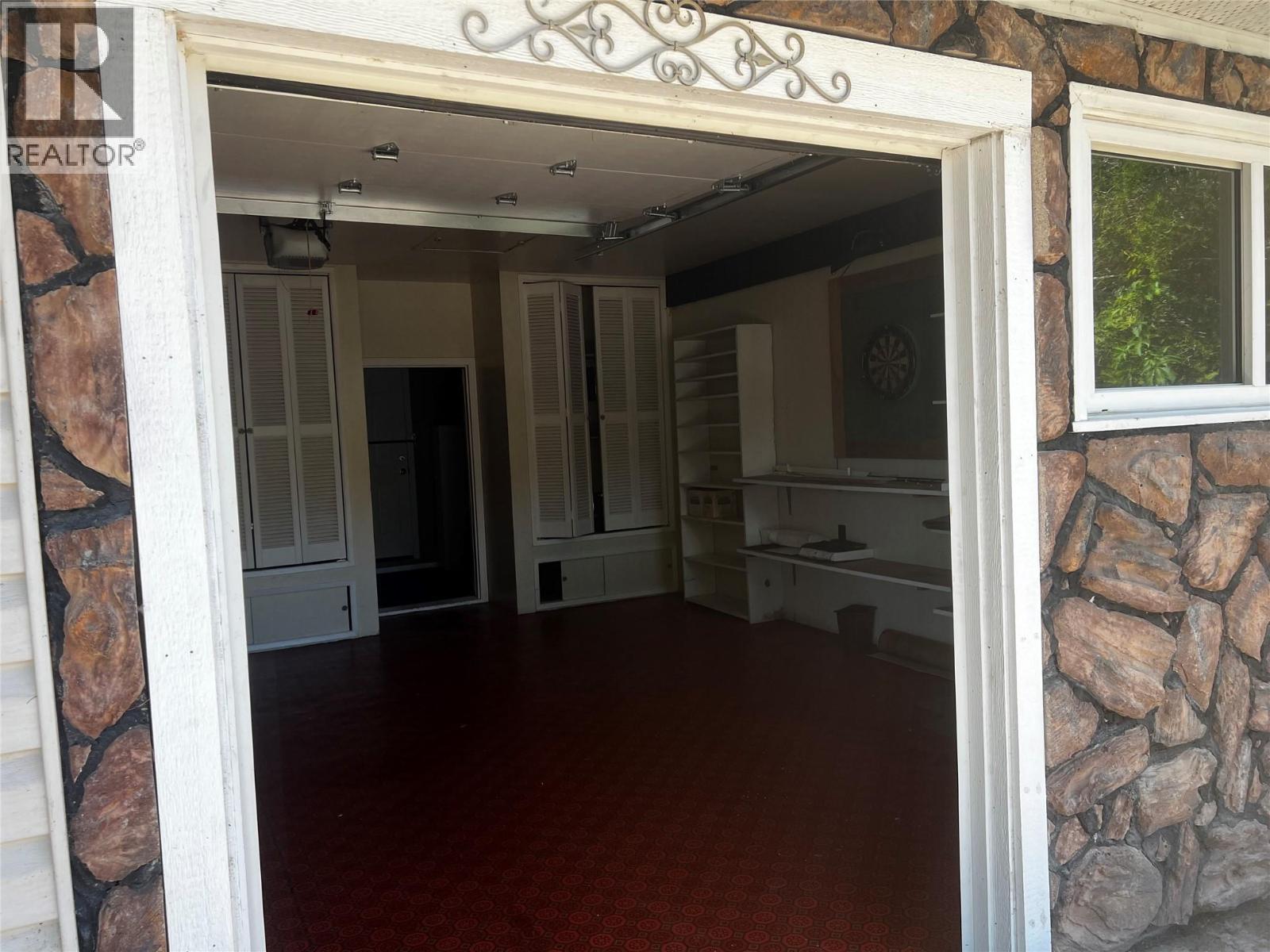 small garage door going into working / garage area - 28 Willow Crescent, Osoyoos, BC - Indoor Photo Showing Other Room