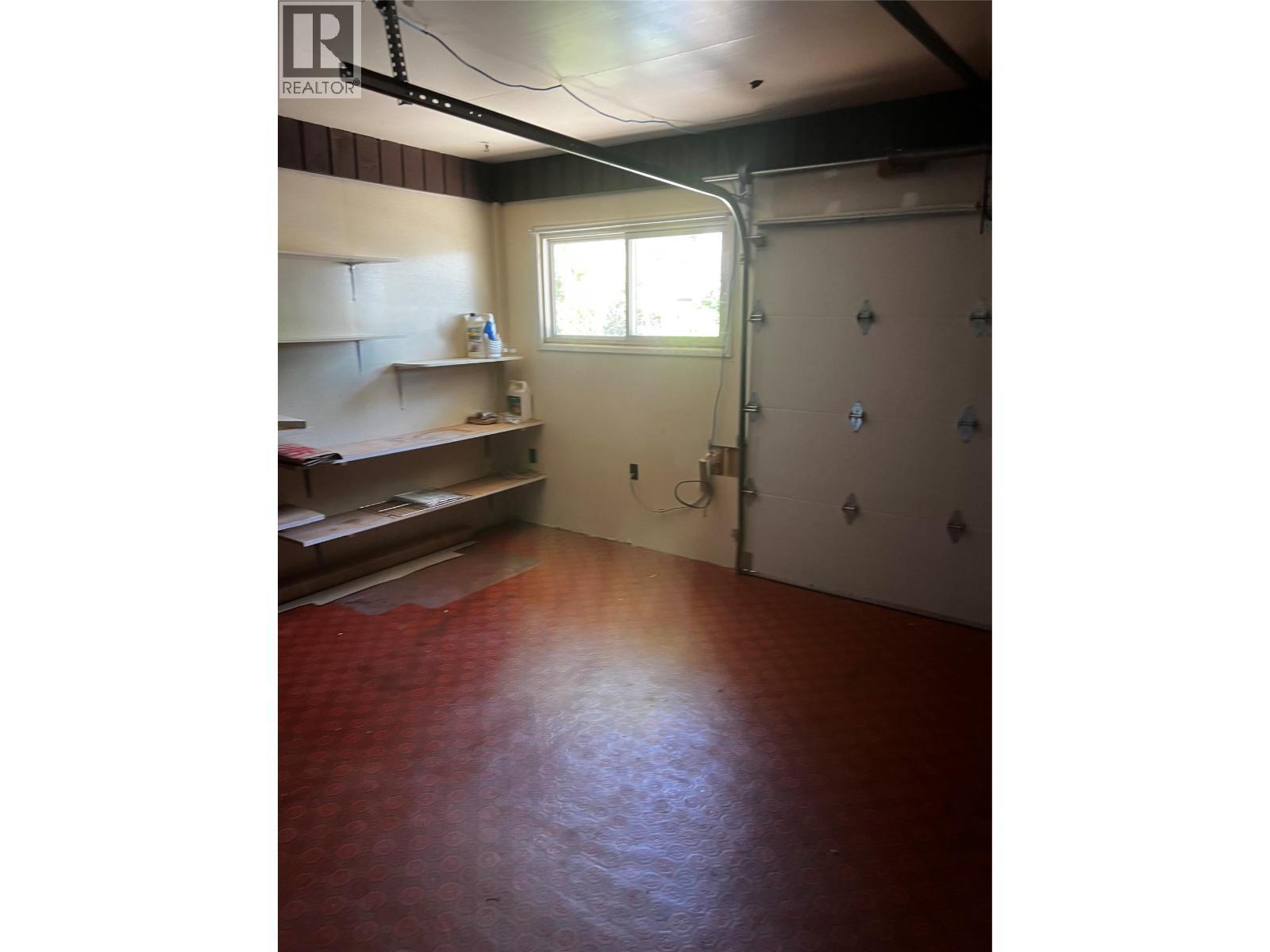 small garage door to working area - 28 Willow Crescent, Osoyoos, BC - Indoor Photo Showing Other Room