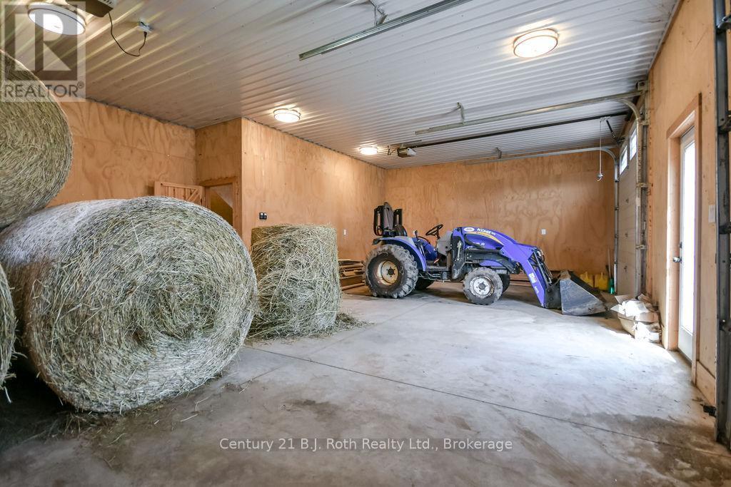 Hay and Equipment Storage with Double Entry Doors - 465 Ridge Road E, Oro-Medonte, ON - Indoor Photo Showing Garage