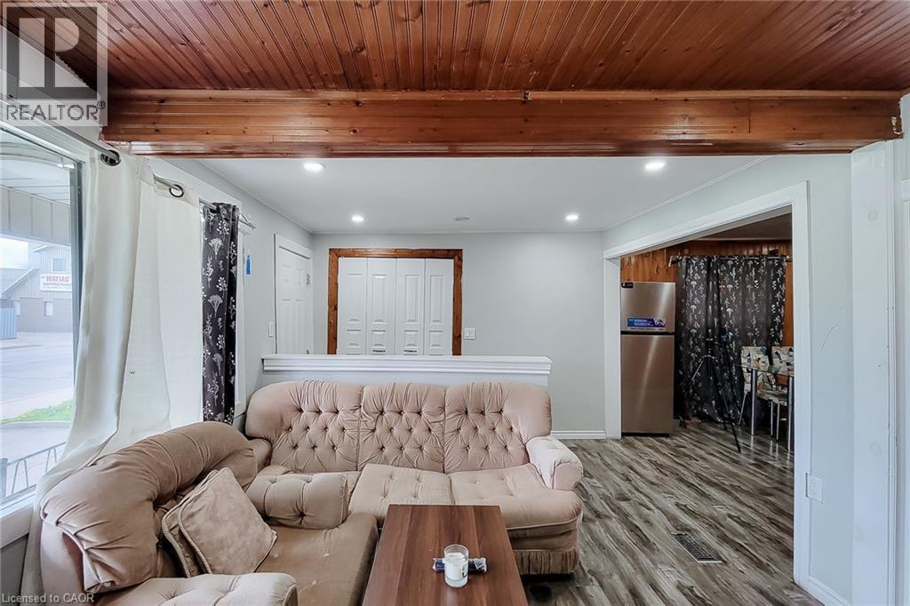 Wood-paneled ceiling with an exposed wood beam, recessed lighting, and wood-finish flooring - 463 Wellington Street N, Hamilton, ON - Indoor
