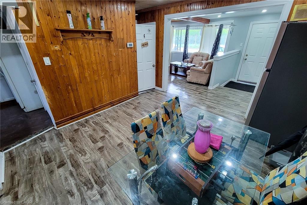 Dining area featuring wood-finish flooring and paneled wall accents - 463 Wellington Street N, Hamilton, ON - Indoor Photo Showing Other Room