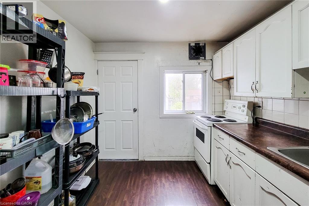 Kitchen featuring wood-finish flooring and white cabinetry - 463 Wellington Street N, Hamilton, ON - Indoor Photo Showing Kitchen