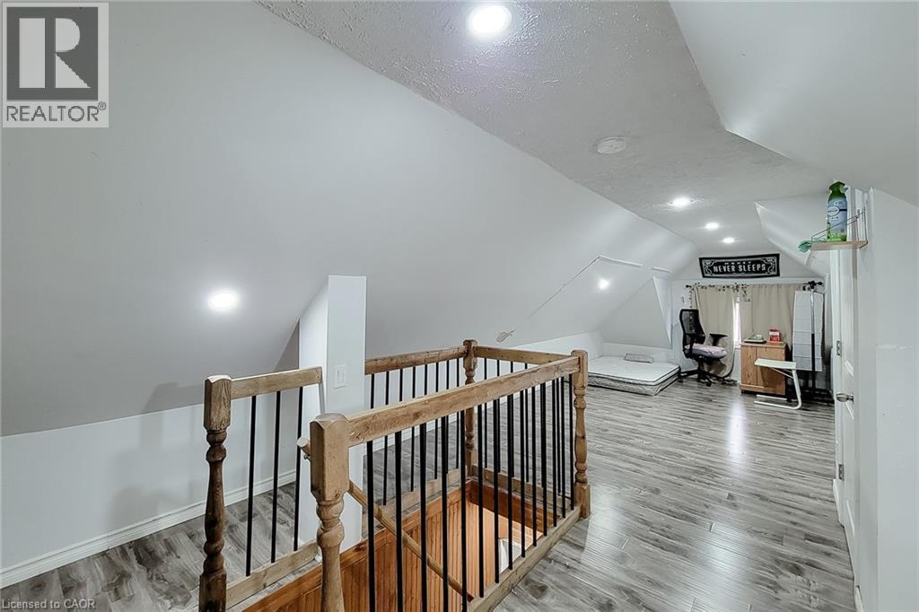 Spacious loft area featuring wood-finish flooring, recessed lighting, and sloped ceilings - 463 Wellington Street N, Hamilton, ON - Indoor Photo Showing Other Room