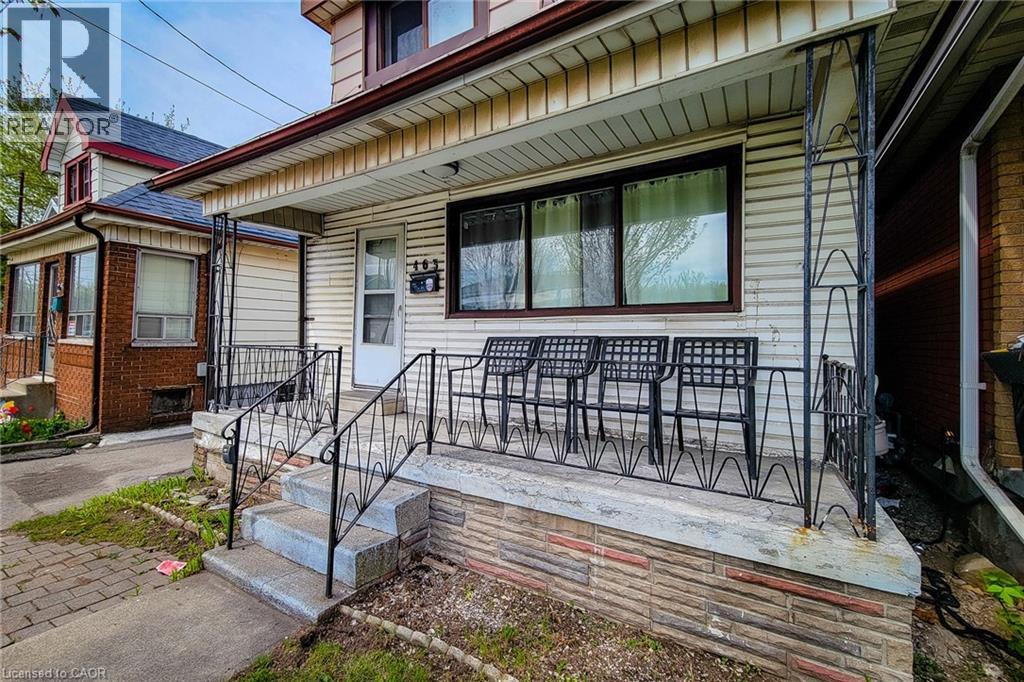 Front porch featuring decorative wrought iron railing and concrete steps - 463 Wellington Street N, Hamilton, ON - Outdoor