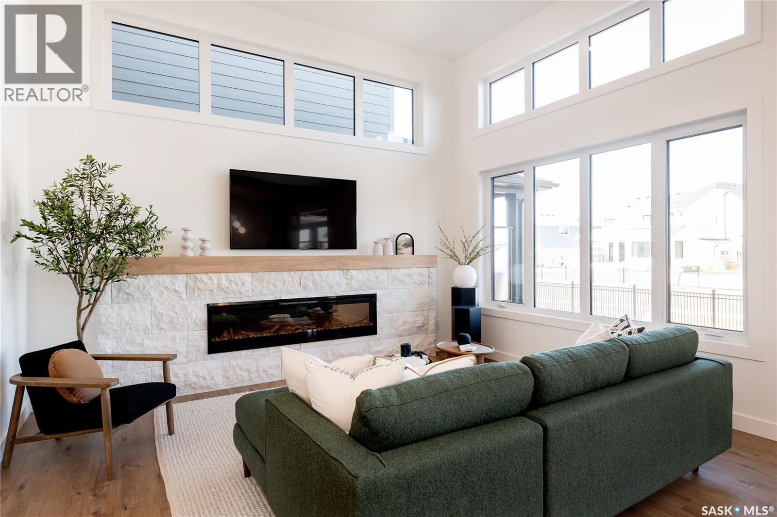 114 Cockcroft Manor, Saskatoon, SK - Indoor Photo Showing Living Room With Fireplace