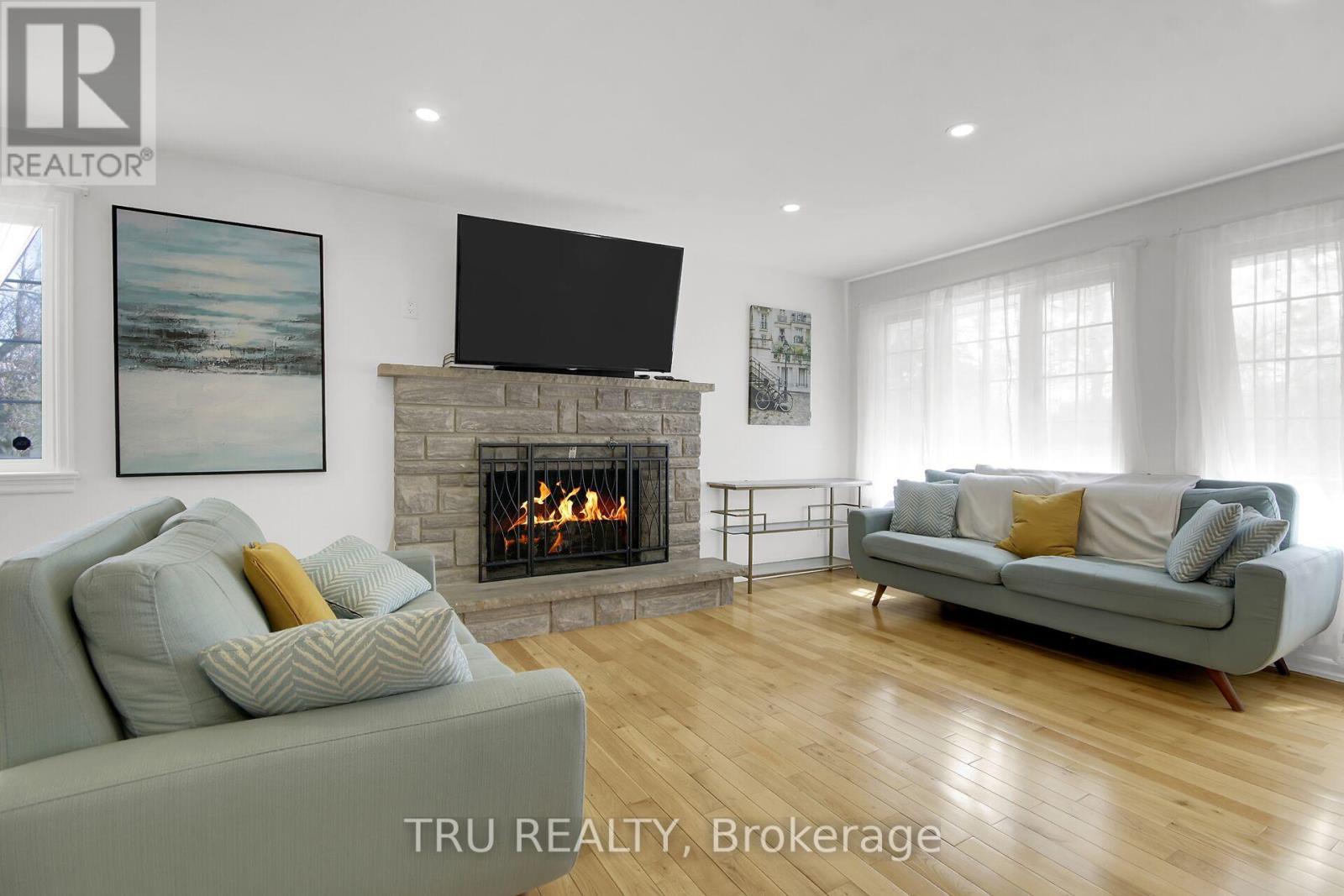 7038 Shields Drive, Ottawa, ON - Indoor Photo Showing Living Room With Fireplace