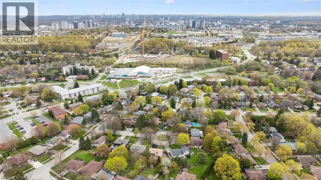 Expansive aerial view showcasing a residential area with varied housing styles and mature trees - 176 Woodville Place, Waterloo, ON - Outdoor With View
