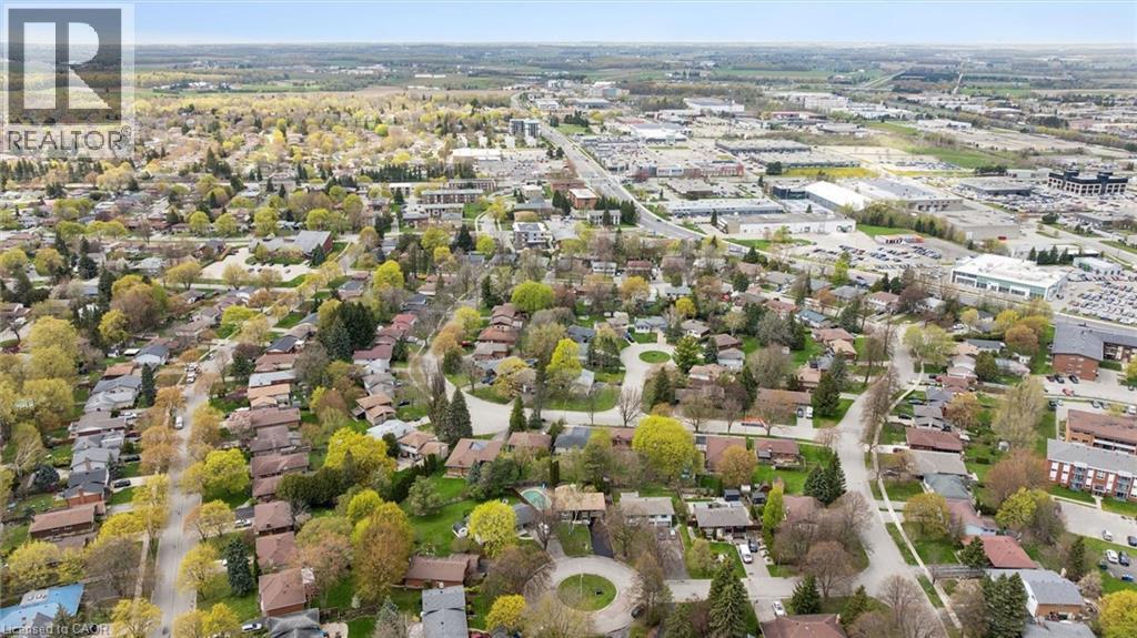 Aerial perspective showcasing a residential neighborhood with established trees and detached homes - 176 Woodville Place, Waterloo, ON - Outdoor With View