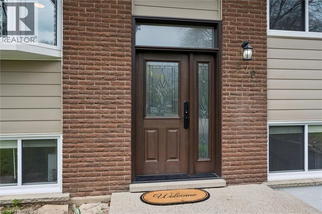 Entryway featuring a brown wood-finish door with decorative glass, a coordinating sidelight, and an overhead transom window - 176 Woodville Place, Waterloo, ON - Outdoor With Exterior