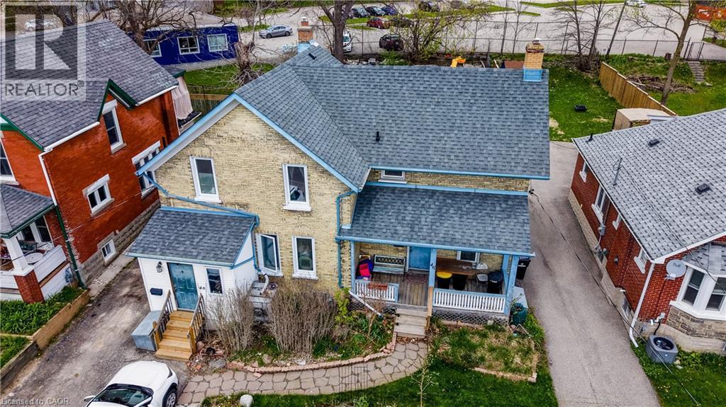 Two-story brick residence featuring a charcoal shingle roof and a covered front porch - 46 Shanley Street, Kitchener, ON - Outdoor With Deck Patio Veranda