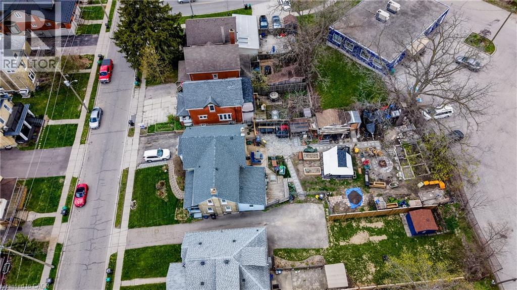 Aerial perspective showcasing a residential street with mature trees and a commercial building - 46 Shanley Street, Kitchener, ON - Outdoor With View