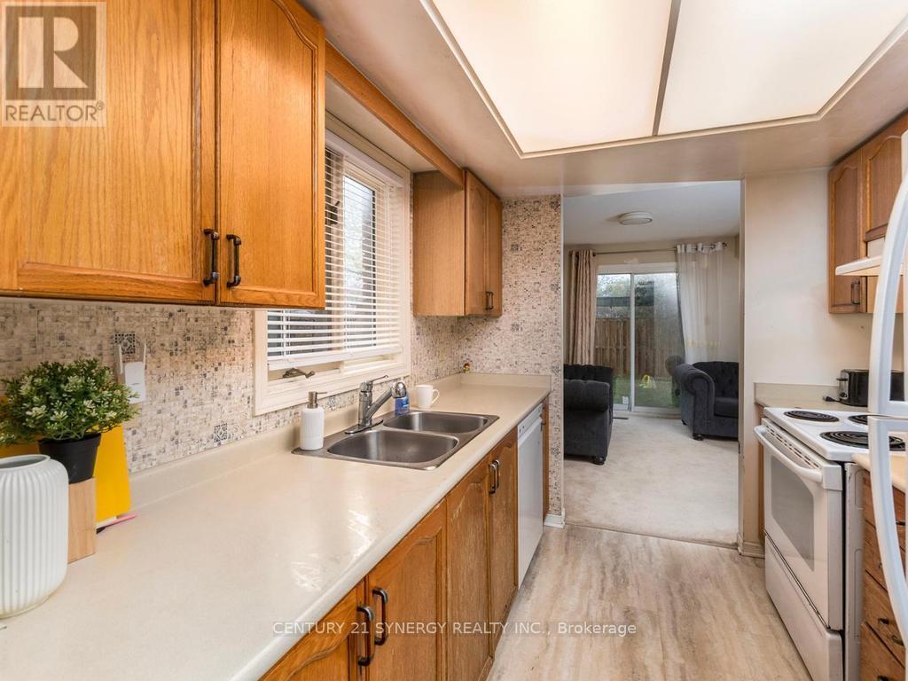 Galley style kitchen with lots of windows. - 1 Winnegreen Court, Ottawa, ON